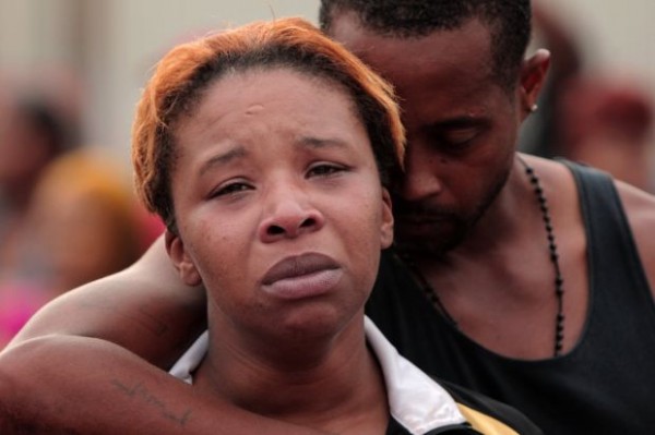 Huy Mach, hmach@post-dispatch.com. caption: Lesley McSpadden is comforted by her husband, Louis Head, after her 18-year-old son was shot and killed by police earlier in the afternoon in the 2900 block of Canfield Drive on Saturday, Aug. 9, 2014, in Ferguson. Head is the step-father. 