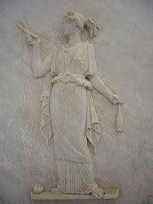 Bas relief of Atropos, shears in hand, cutting the thread of life